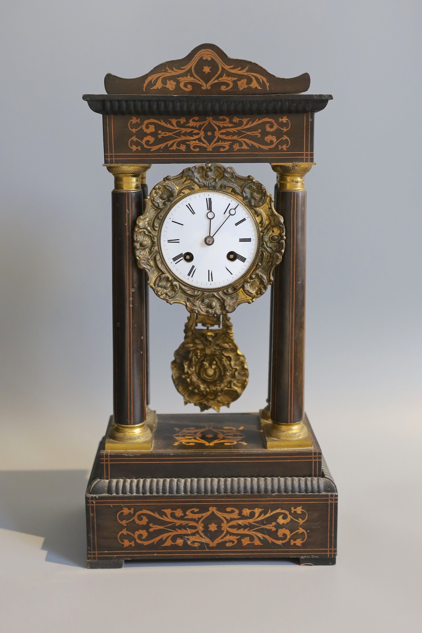 A 19th century French marquetry inlaid and gilt metal mounted ebonised eight day portico mantel clock, height 45cm